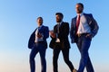 Company leaders take a walk on sunset sky background