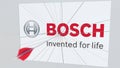 Archery arrow breaks glass plate with BOSCH company logo. Business issue conceptual editorial 3D rendering