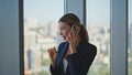 Company manager speaking cell in glass office. Beautiful woman laughing on call Royalty Free Stock Photo