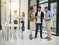 The company that promotes a collaborative working culture. a group of colleagues having a meeting in a modern office.