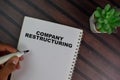 Company Restructuring write on a book isolated on Wooden Table Royalty Free Stock Photo