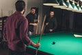 company of successful men beside gambling pool table Royalty Free Stock Photo