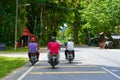 A company of three people ride motorbikes along the road. Hot sunny day Royalty Free Stock Photo