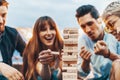 The company of young people playing jenga