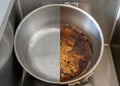 Compare burnt pan image before and after cleaning the unclean able stained pot from burnt cooking pot. The dirty stainless steel p Royalty Free Stock Photo