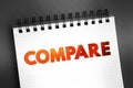 Compare - estimate, measure, or note the similarity or dissimilarity between, text concept on notepad Royalty Free Stock Photo