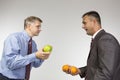 Comparing apples to oranges Royalty Free Stock Photo