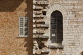 Ancient medieval window in contrast to a modern window.