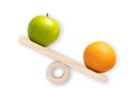 Comparison and differentiation. Apple and orange on a seesaw