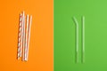 Comparison concept. Reusable Eco Friendly Glass Drinking Straws vs Colorful Disposable Plastic Straws. No plastic, Zero Waste,