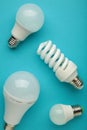Comparison of different light bulbs on blue background Royalty Free Stock Photo