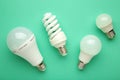 Comparison of different light bulbs on mint background Royalty Free Stock Photo