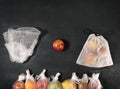 Comparison of disposable and reusable packages, apple between plastic package and eco grocery mesh with fruits