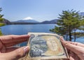 Comparison of japanese 1000 yen banknote & Mt. fuji view at Motosu lake Royalty Free Stock Photo