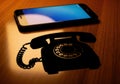 Of comparison of old and new technology rotary phone and smartphone Royalty Free Stock Photo