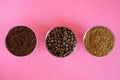 Comparison of three types of coffee in one picture: roasted beans, ground, soluble granulated. In round glass bowls on a pink