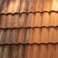 Comparison tiles roof top before and after cleaning moss lichen with brush Royalty Free Stock Photo