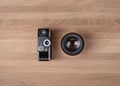 Comparison of two cameras, vintage one and modern lens. Photography development concept. Copy space on wooden background