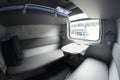 Compartment and berth with bed-linen packages in Railways First Class sleeping carriage of a passenger train, interior Royalty Free Stock Photo