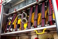 Compartment of rolled up fire hoses on a fire engine. Rescue fire truck equipment. Close up