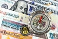 Compass with arrow pointing up on the background of Egyptian pounds and American dollars Royalty Free Stock Photo