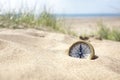 Compass on the beach with sand and sea