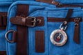 Compass and blue travel backpack, tourist items close-up