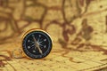 Compass on blur vintage map background, retro color tone, direction journey planning concept, blank space, top view