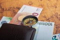 Compass,  box, wallet and Euro banknotes  on an old map Royalty Free Stock Photo