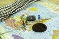 a compass a climbing rope and an old copper coin on the geographical map the buttons mark the places the concept of Royalty Free Stock Photo