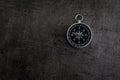 Compass on dark black textured cement with copy space using as d Royalty Free Stock Photo