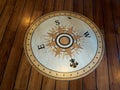 Compass directions wind rose on a wooden floor of a boat