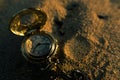 Compass on dirt soil background with sunset light. Royalty Free Stock Photo