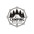 Compass and forest camping logo emblem summer camping vector illustration with tent and pine trees silhouette