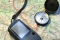 Compass with a GPS device on a topographic map Royalty Free Stock Photo