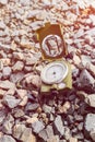 Compass on gravel mountain hiking trail.