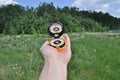 Compass in hand, against background of the forest.