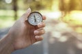 Compass in the hand with background of green nature Royalty Free Stock Photo