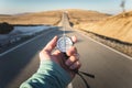 Compass in Hand mountain road background .Vintage Tone Royalty Free Stock Photo