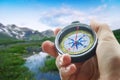 Compass and hand in mountains Royalty Free Stock Photo