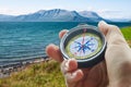 Compass and hand in mountains Royalty Free Stock Photo