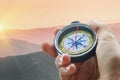 Compass and hand in mountains Royalty Free Stock Photo