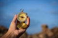 Compass in the hand on the nature background. Royalty Free Stock Photo