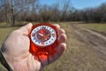 Compass in the hand on a walk.