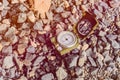 Compass instrument on gravel mountain hiking trail.