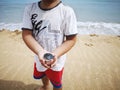 A boy holding a compass showing the direction point to north.