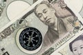 Compass on Japanese Yen banknotes money using as Japan economic problem solving, financial direction or key to get success in Royalty Free Stock Photo