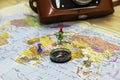 a compass lying on a geographical map marks the place of travel with buttons in the background an old camera is the Royalty Free Stock Photo