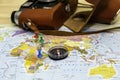 a compass lying on a geographical map marks the place of travel with buttons in the background an old camera is the Royalty Free Stock Photo