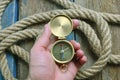 Compass in man hand. Nautical, navigation background.